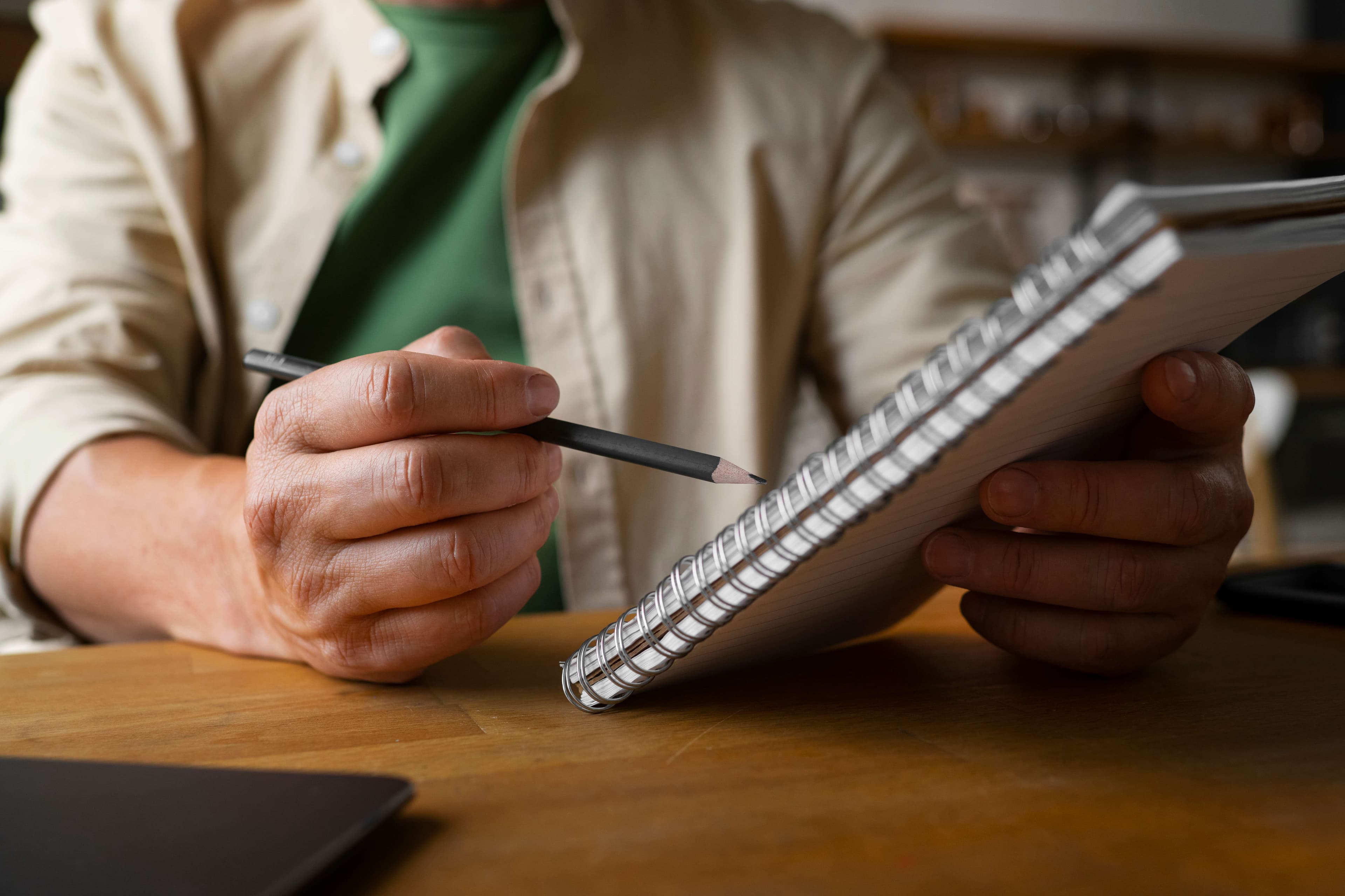 man writing notepad